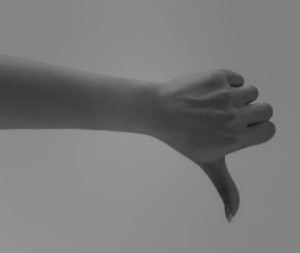 black and white hand with thumb's down
