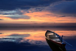 rowboat with sunset background
