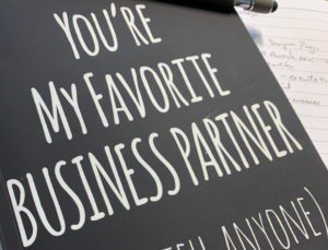 black card with white text reading you're my favorite business partner